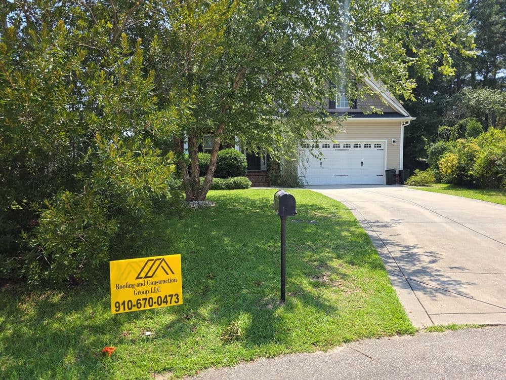 House with landscaping and construction sign on front yard, showcasing services offered.